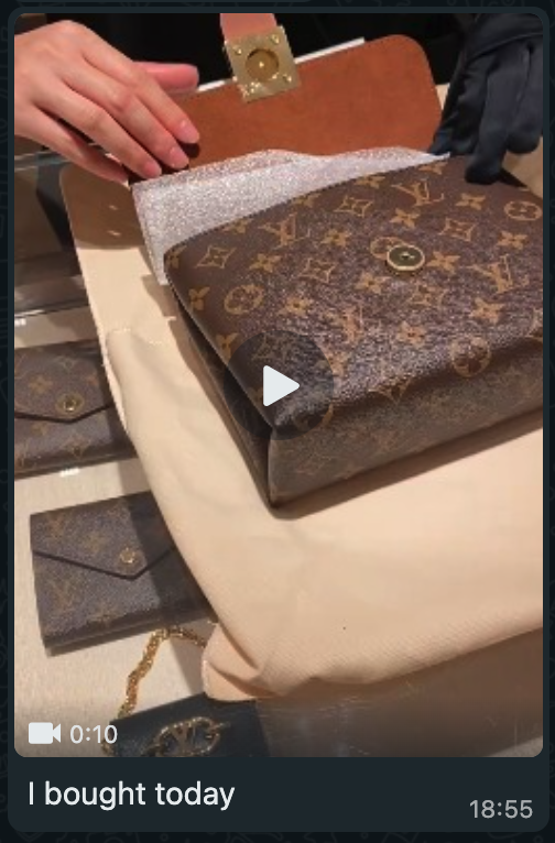 Screenshot of a video in a chat saying 'I bought today' the video preview shows an unpacking of a luxury Louis Vuitton bag