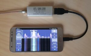 photo of an Android smartphone connected to an RTL-SDR antenna
