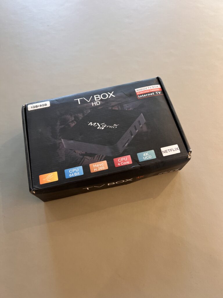 A photo of the Android TV Box. It is black, called MXQ Pro 4K. It shows some hardware specifications that are not relevant to this article.