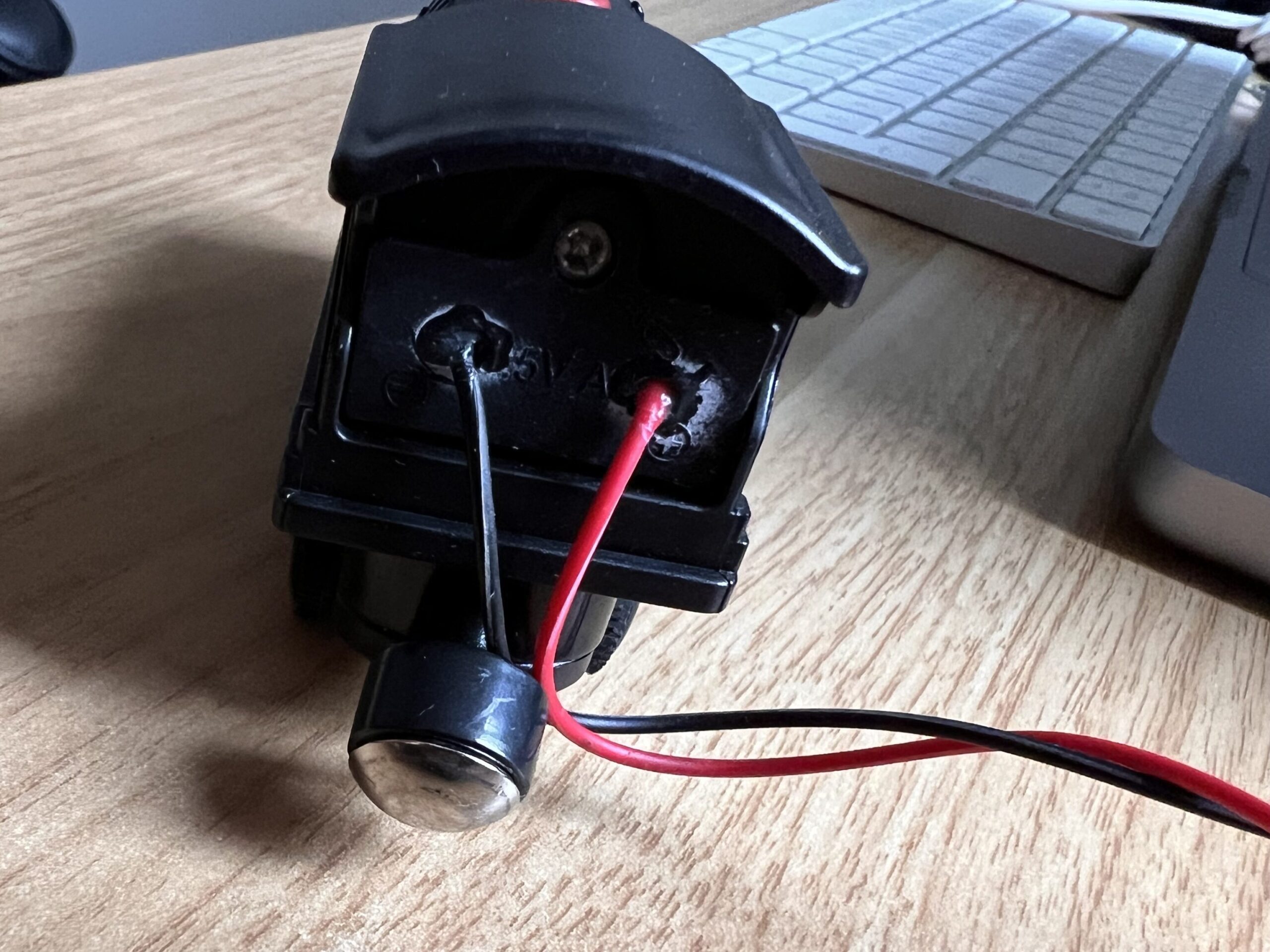 photo of a toy railwaycart with two wires sticking out